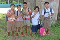 Students hold the young plant.